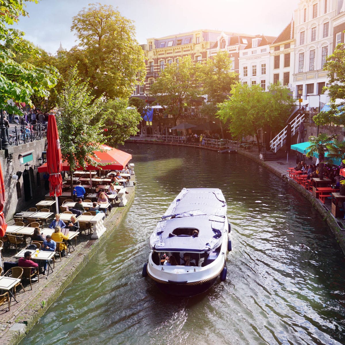 Canal Oudegracht with boat and sidewalk cafes in downtown Utrecht